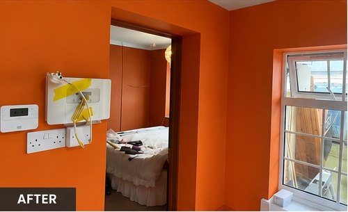 Orange bedroom mid-decoration with white woodwork, Leicester
