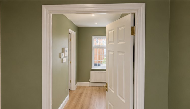 Sage green landing and doorway with white panelled door, Leicester